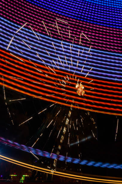 istock Two rides in motion in amusement park, night illumination. Long exposure. 1186484155