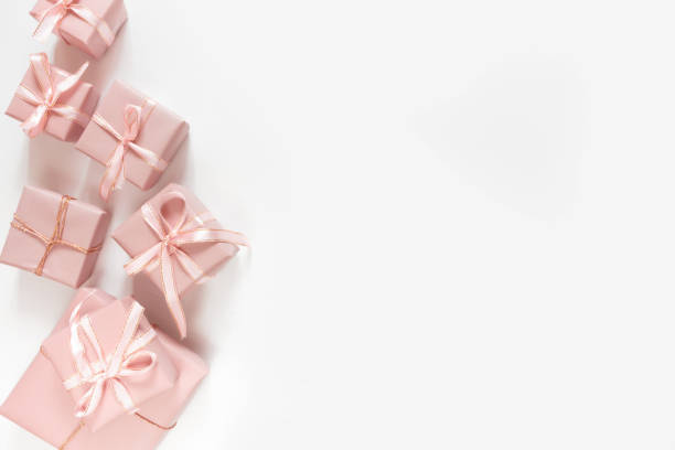 istock Christmas pink flat lay. Holiday boxes in pink packaging, fir branches on a light background. Christmas winter holiday congratulation invitation birthday wedding 1186489940