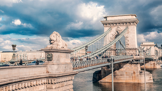 Budapest, Hungary - Nov 3th 2017: The Széchenyi Chain Bridge is a suspension bridge that spans the River Danube between Buda and Pest, the western and eastern sides of Budapest, the capital of Hungary. Dramatic sky.