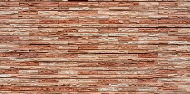 istock Pattern from lite brown decorative slate stone brick wall surface. panorama of brown stone wall texture background. 1186504733