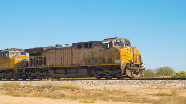 istock CLOSE UP: Locomotive moving long freight container train along railroad tracks 1186505789