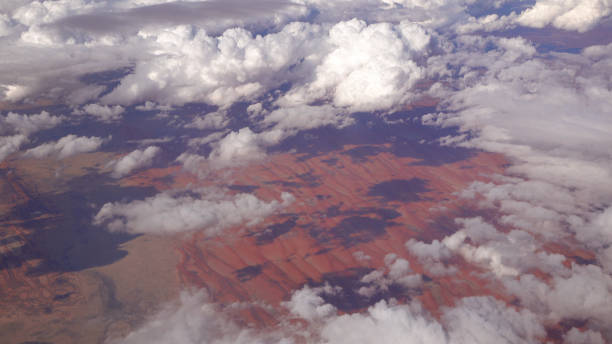 istock View of red arid sandy landscape and numerous puffy white clouds 1186506032
