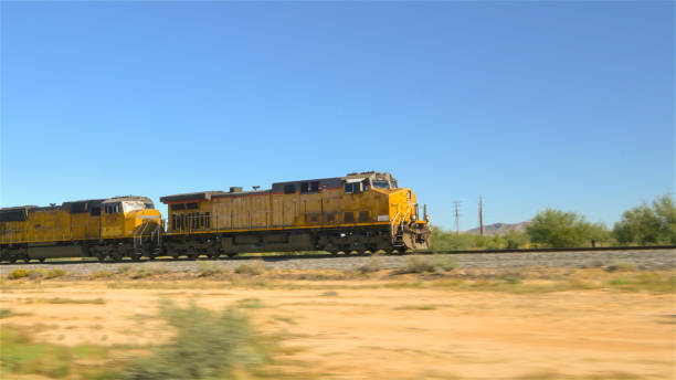 istock CLOSE UP: Locomotive moving long freight container train along railroad tracks 1186506115