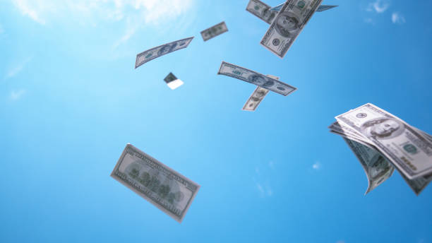 istock CLOSE UP: Money hundred $ dollar bills falling down from blue skies 1186506155