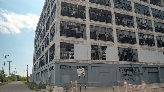Detroit, USA - October 20, 2019: The wall of the old Fisher Body Works factory in Detroit has been painted a solid gray color to hide the graffiti.