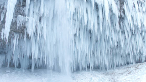 istock CLOSE UP: Mountain river waterfall frozen into numerous white icicles in winter 1186508452