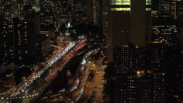 istock AERIAL, CLOSE UP: Vehicles traveling along Brooklyn Bridge overpass at night 1186508480