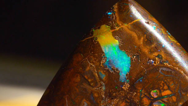 istock CLOSE UP Stunning piece of iridescent precious stone Opal sparkling under light 1186512114