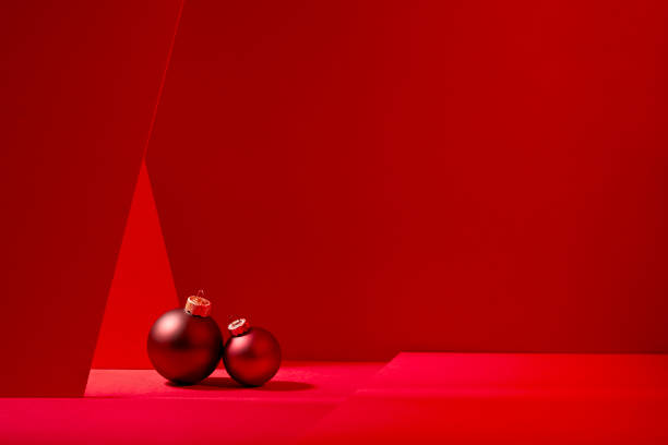 Red Christmas baubles in red background.