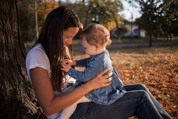 istock Mother with daughter enjoying autumn day 1186512702