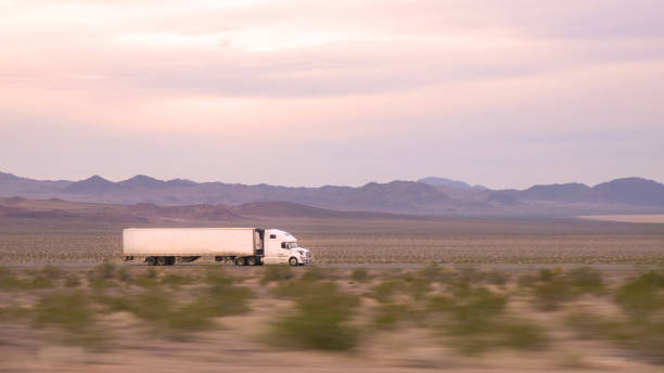 クローズアップ:貨物セミトラックの運転と交通量の多い高速道路上の商品の輸送 - fuel tanker close up semi truck multiple lane highway ストックフォトと画像