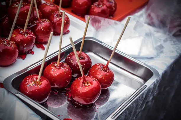 Red sugared apples on a metal tray