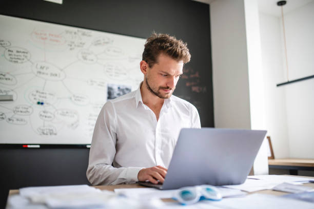 istock Mature Caucasian technician solving a problem on laptop in the office 1186518989