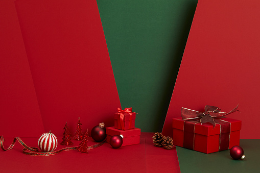 Christmas gifts on red and green background with Christmas decoration. Suitable for Christmas card.