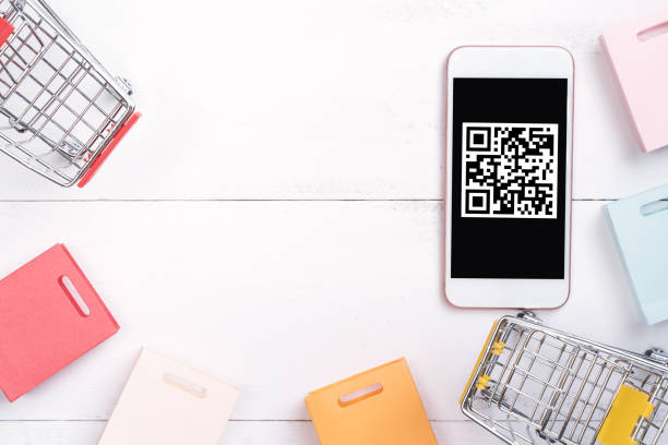 istock Abstract online shopping, mobile payment with QR code design concept element, colorful cart, paper bag on wooden table background, top view, flat lay 1186519407