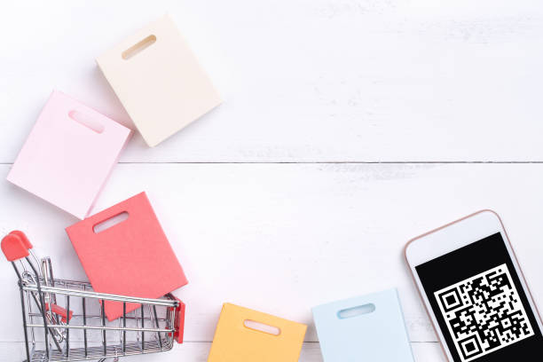 istock Abstract online shopping, mobile payment with QR code design concept element, colorful cart, paper bag on wooden table background, top view, flat lay 1186519411