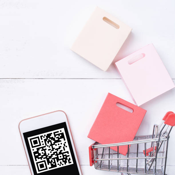 istock Abstract online shopping, mobile payment with QR code design concept element, colorful cart, paper bag on wooden table background, top view, flat lay 1186519414