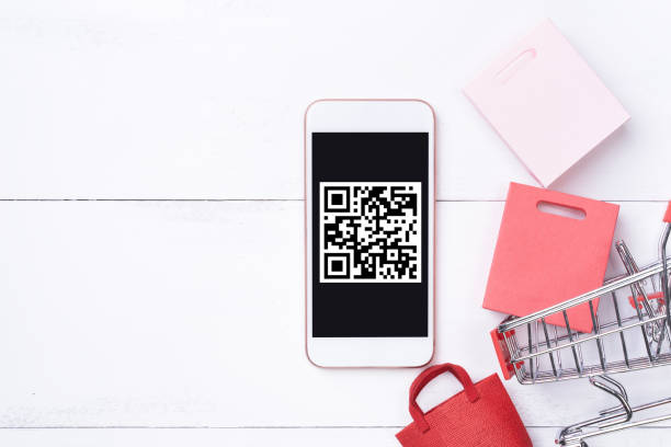 istock Abstract online shopping, mobile payment with QR code design concept element, colorful cart, paper bag on wooden table background, top view, flat lay 1186519421