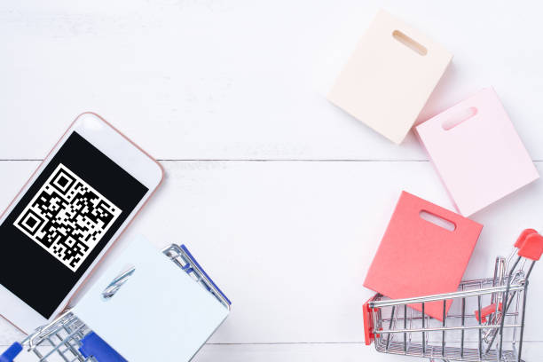 istock Abstract online shopping, mobile payment with QR code design concept element, colorful cart, paper bag on wooden table background, top view, flat lay 1186519456