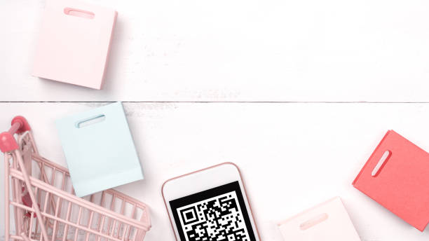 istock Abstract online shopping, mobile payment with QR code design concept element, colorful cart, paper bag on wooden table background, top view, flat lay 1186519458