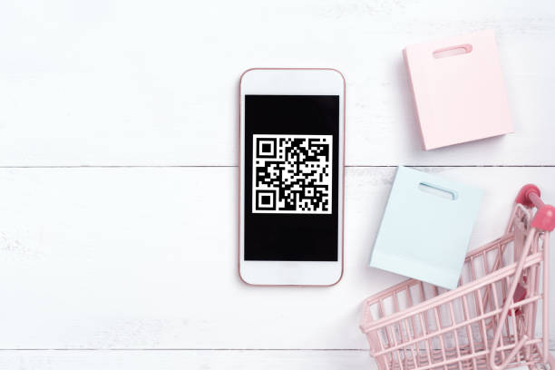 istock Abstract online shopping, mobile payment with QR code design concept element, colorful cart, paper bag on wooden table background, top view, flat lay 1186519466