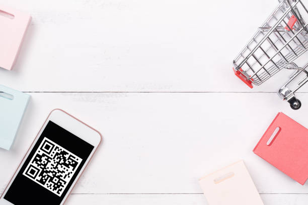 istock Abstract online shopping, mobile payment with QR code design concept element, colorful cart, paper bag on wooden table background, top view, flat lay 1186519467
