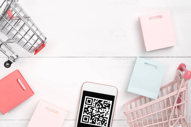 istock Abstract online shopping, mobile payment with QR code design concept element, colorful cart, paper bag on wooden table background, top view, flat lay 1186519468