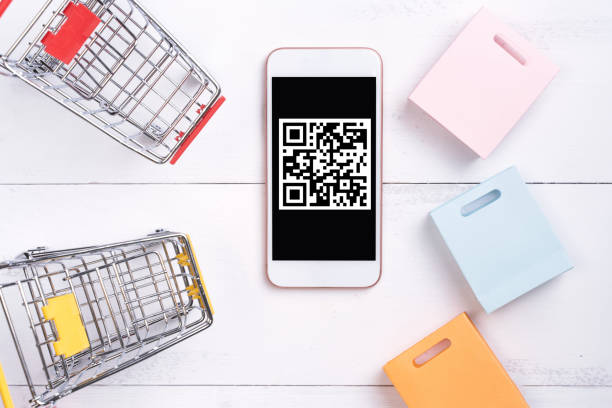istock Abstract online shopping, mobile payment with QR code design concept element, colorful cart, paper bag on wooden table background, top view, flat lay 1186519483