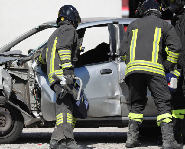 istock team of firefighters opens the damaged car 1186520511