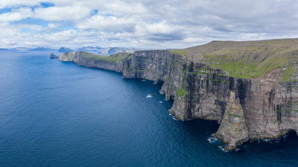 istock Panoramic aerial view from Sandoy island cliffs under the clouds 1186523367