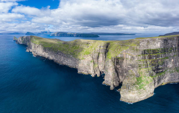 istock Panoramic aerial view from Sandoy island cliffs under the clouds 1186523385