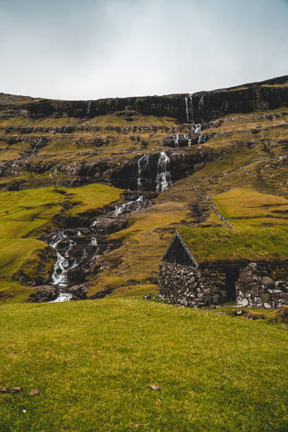 istock Old house near a waterfall in Saksun 1186523839