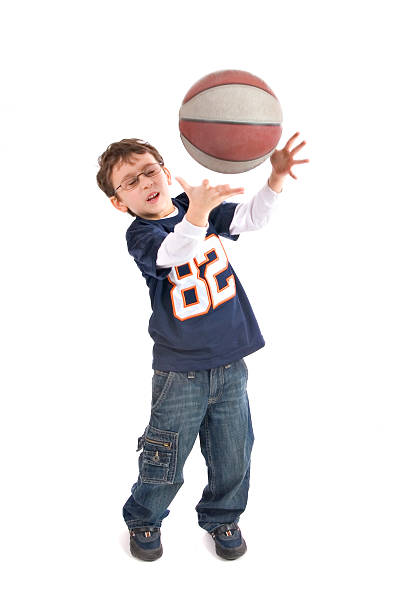 istock little boy catching a basketball 118652479