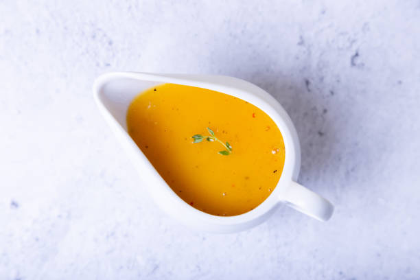 Orange sauce to duck (bird) in a white saucer.
