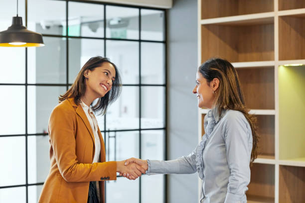 istock Confident businesswomen handshaking in office 1186532015