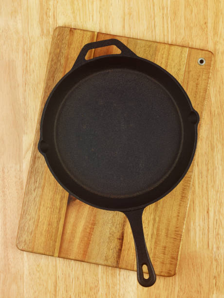 istock Empty cast iron frying pan on wooden table, top view 1186532171