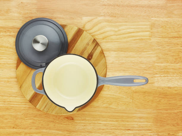 Empty cast iron frying pan on wooden table, top view