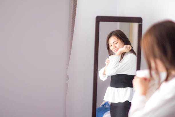 istock young woman making her shirt before goes to work 1186533094