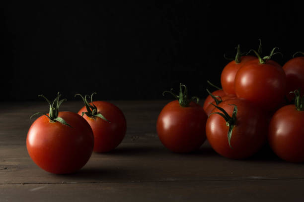 istock Tomatoes on a wooden table 1186533873