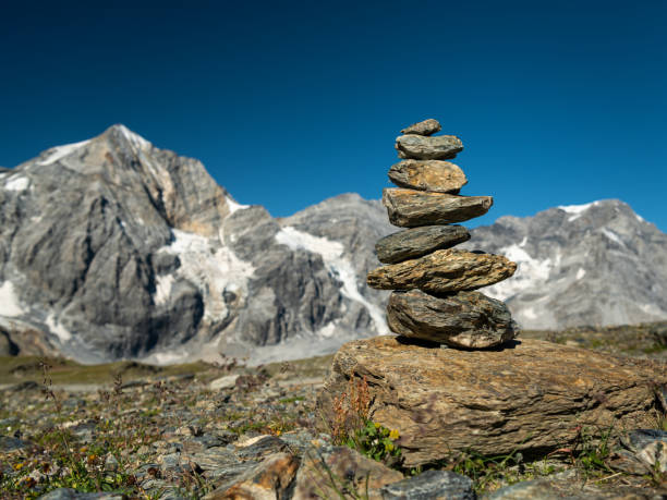 Stacked stones on Hintere Schoentaufspitze (Punta Beltovo di Dentro, South Tyrol, Italy) on a sunny day in summer