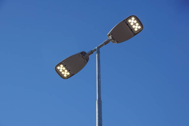 istock Three LED Street Lamps Affixed to an Iron Post Against a Deep Blue Sky 1186539614