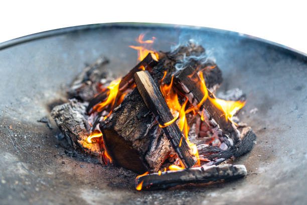 istock A burning wood fire on a metal grate, isolated on a white background with a clipping path. 1186540258
