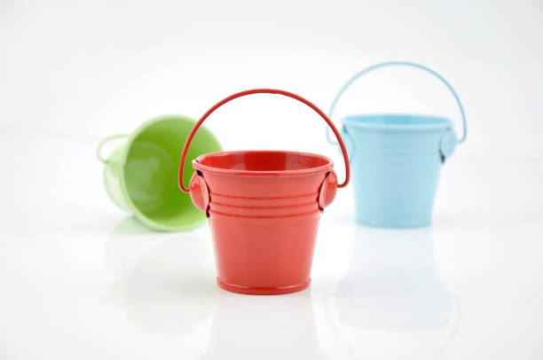 istock Three metal buckets of different colours with handle 1186541331