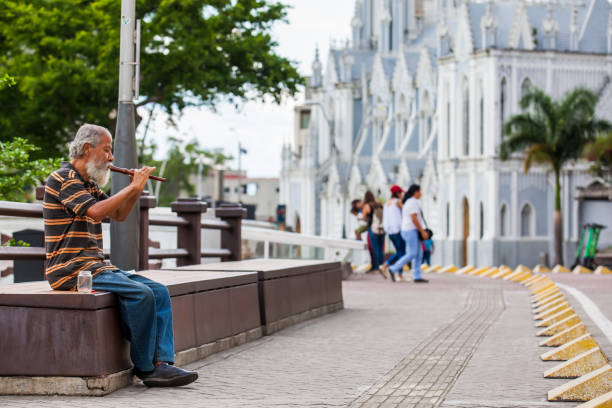 alter mann spielt seine flöte, um geld am river boulevard in cali zu bekommen - ermita stock-fotos und bilder
