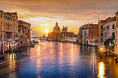 Sunrise colors of Grand Canal and Basilica di Santa Maria della Salute, multiple exposure view from Accademia bridge, Venice, Italy