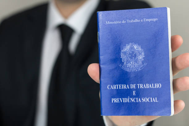 Brazilian Work Permit. Sao Paulo, Brazil - November 2019: Business man wearing suit and tie holding a portfolio work permit. (Translation: Ministry of Labor and Social Security of Brazil). minister clergy photos stock pictures, royalty-free photos & images