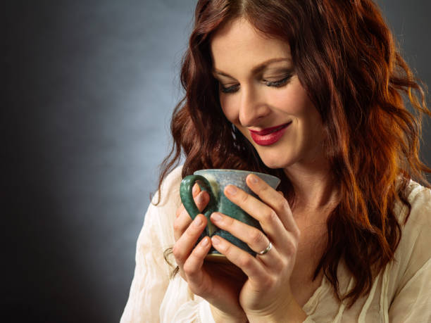 istock Beautiful happy redhead woman drinking coffee 1186546873
