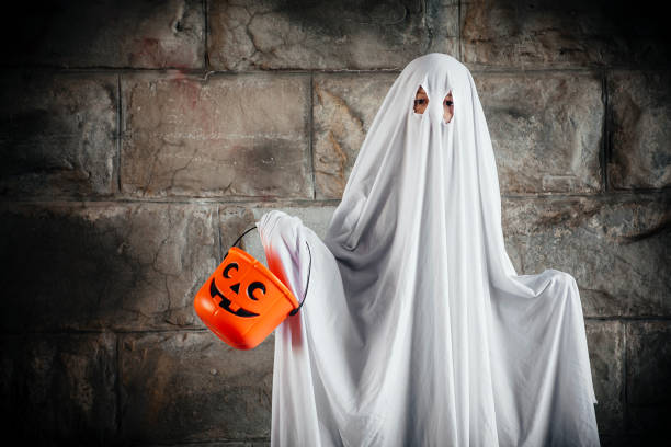istock Bed sheet ghost with pumpkin bucket for Halloween 1186546897