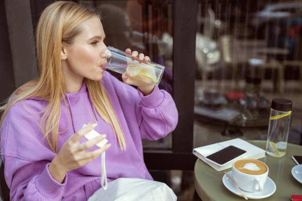 istock Charming female person drinking water with lemon 1186547029