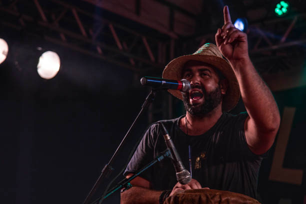 istock Man singing and playing atabaque at a concert 1186547087